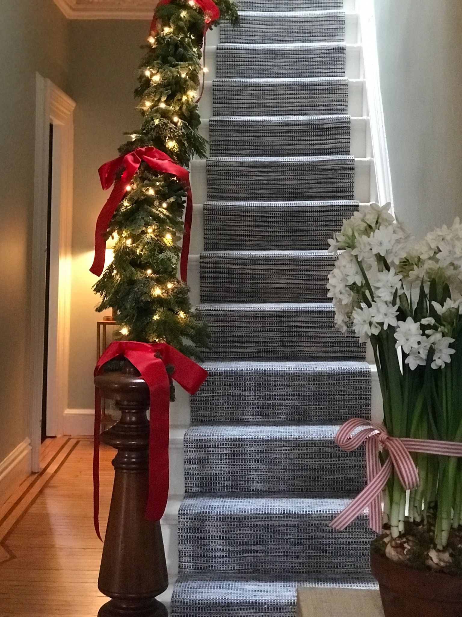 Staircase with blue runner and Christmas garland